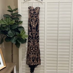 Miss ord Black and Gold sequin Strapless Prom dress with mini train.